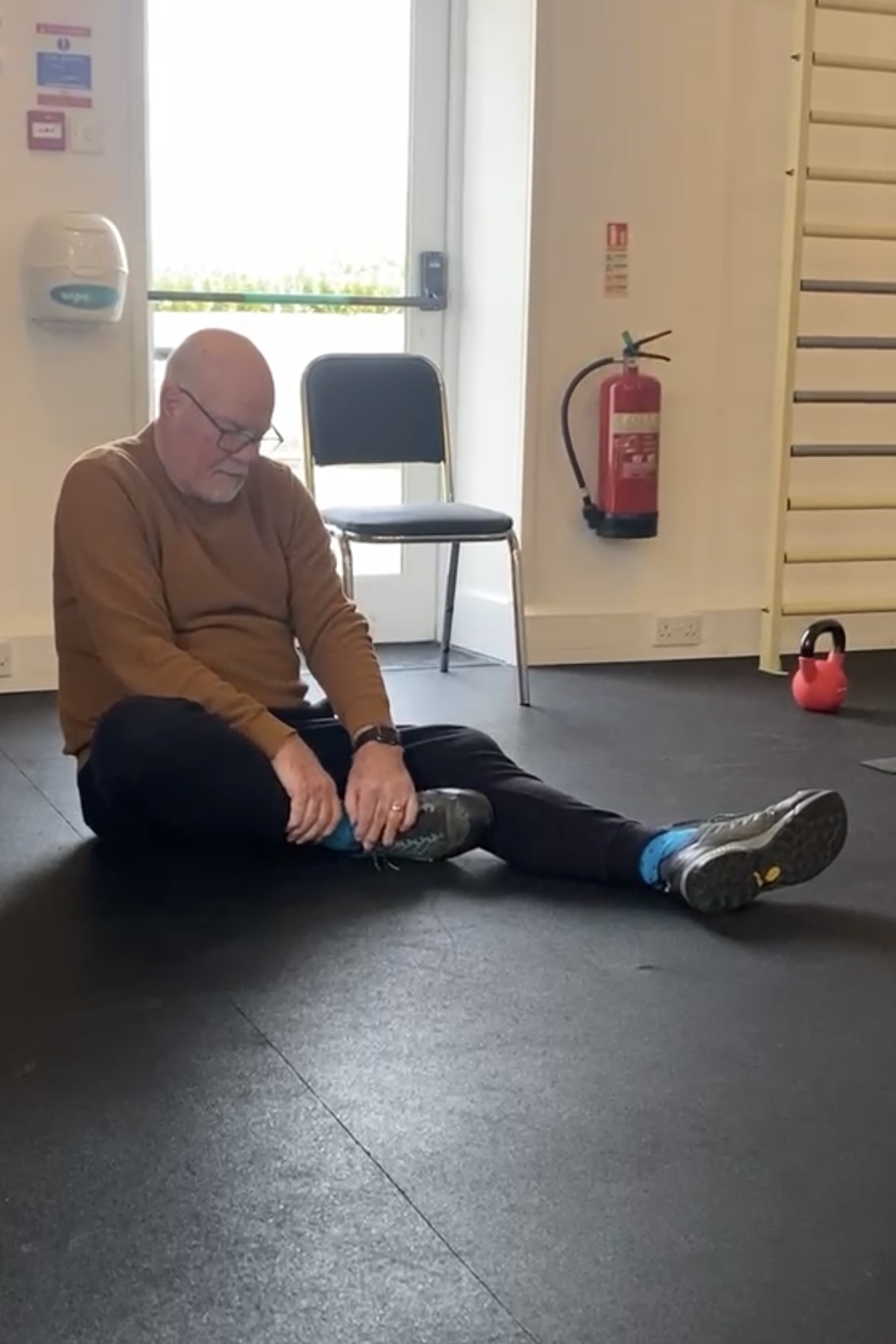 David P. exercising in the Therapy Gym, demonstrating the accessible and supportive environment for people with mobility challenges