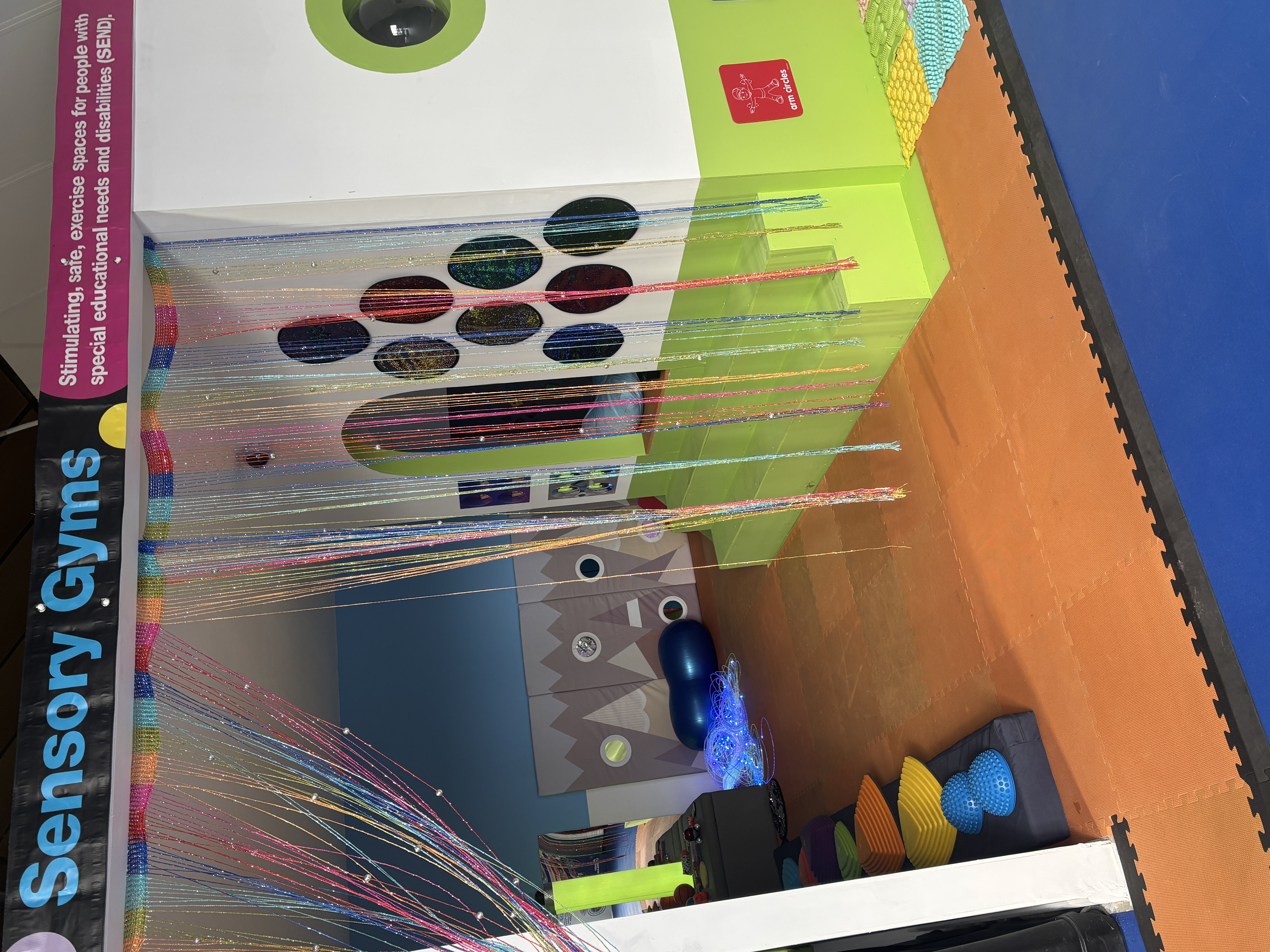 Colorful sensory gym space with adaptive equipment