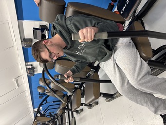 Therapy gym member using accessible exercise equipment at The Angel Centre