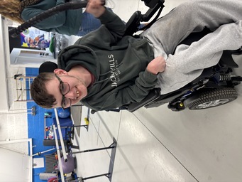 Member working out with specialized equipment in the therapy gym