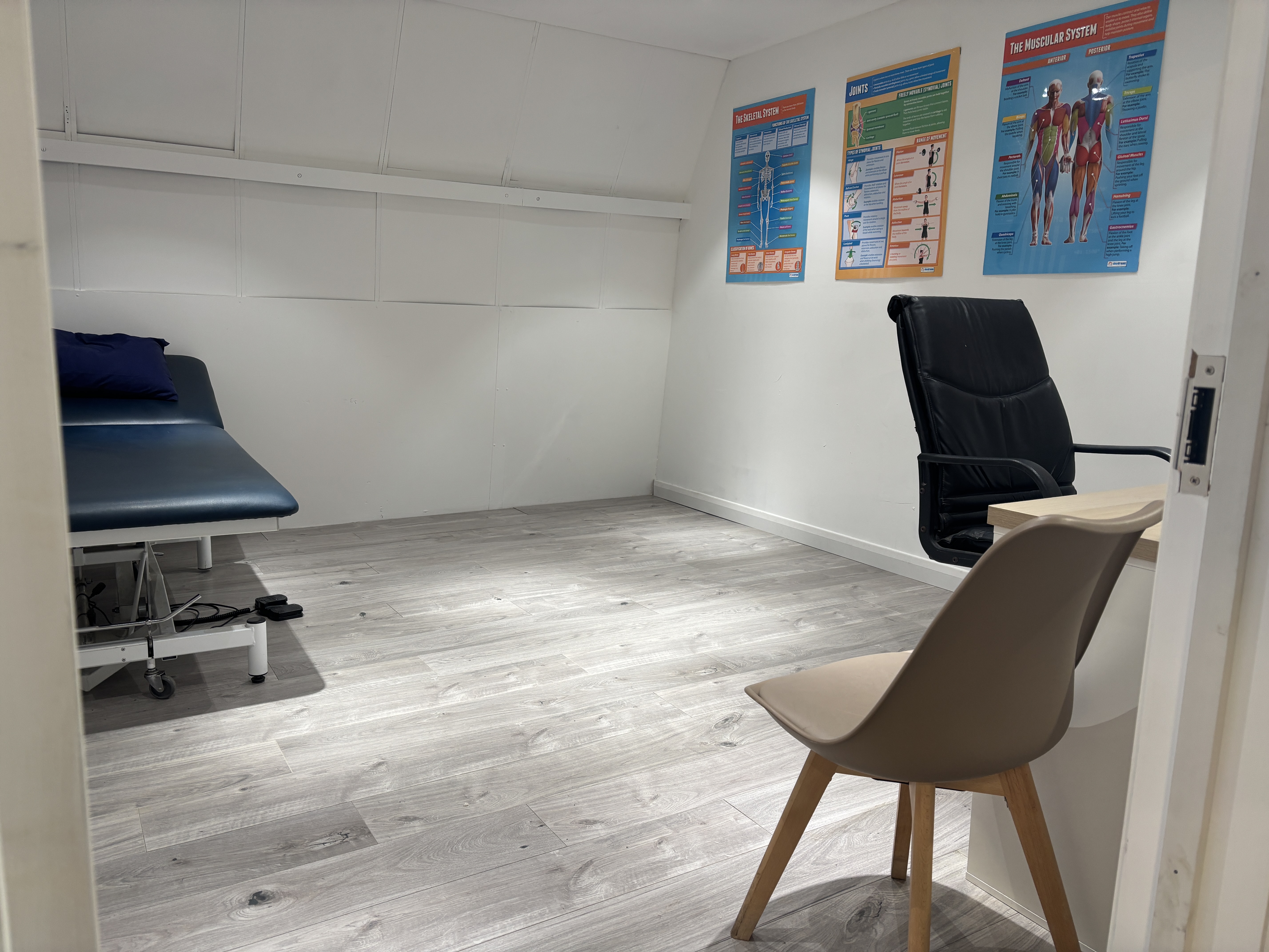 Modern accessible clinic room with examination table and medical equipment at The Angel Centre